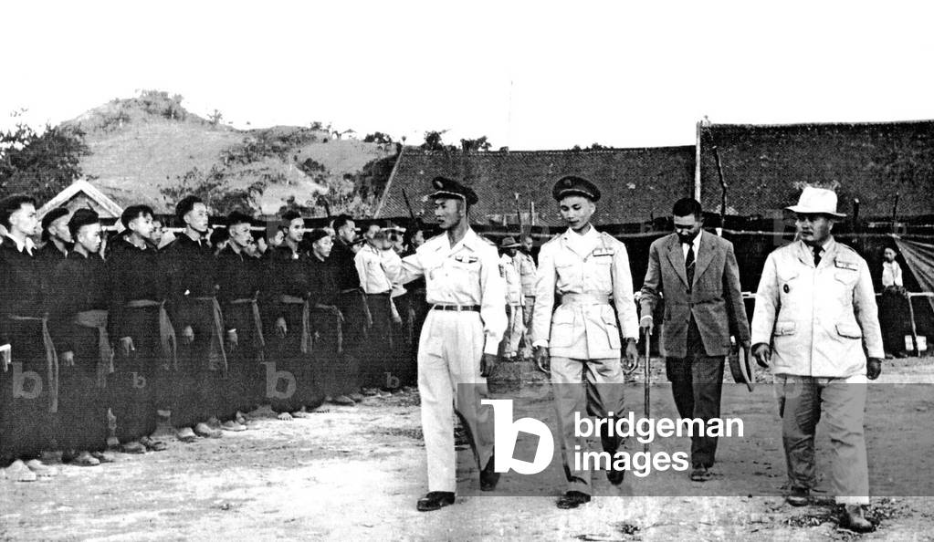 Laos: General Vang Pao (left) reviews Hmong forces with Touby Lyfoung, Hmong politician and leader (right), during the First Indochina War, c. 1954