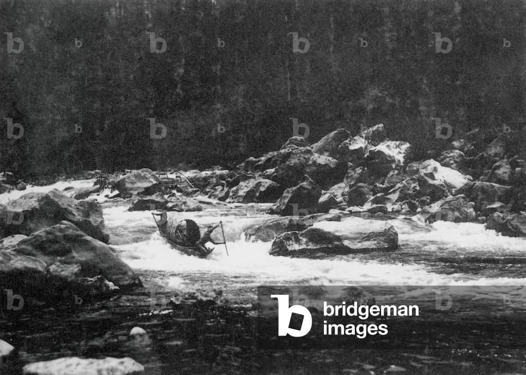 Laos: A dugout barge navigates the rapids on the Mekong River during the 1919 dry season.