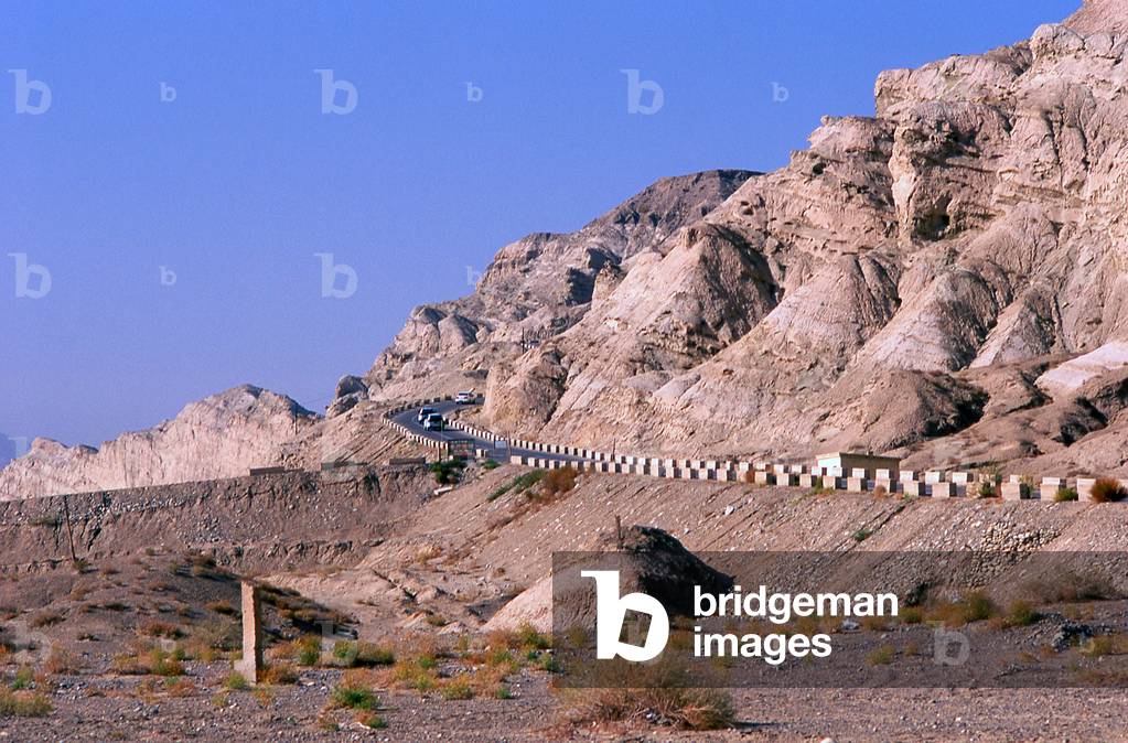 China: A desert road near the Kizil Thousand Buddha Caves, Kuqa, Xinjiang Province