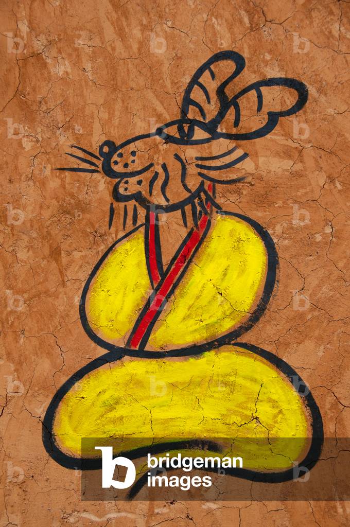 China: Dongba (Naxi) pictographic script adorns a house in the Old Town, Lijiang, Yunnan Province