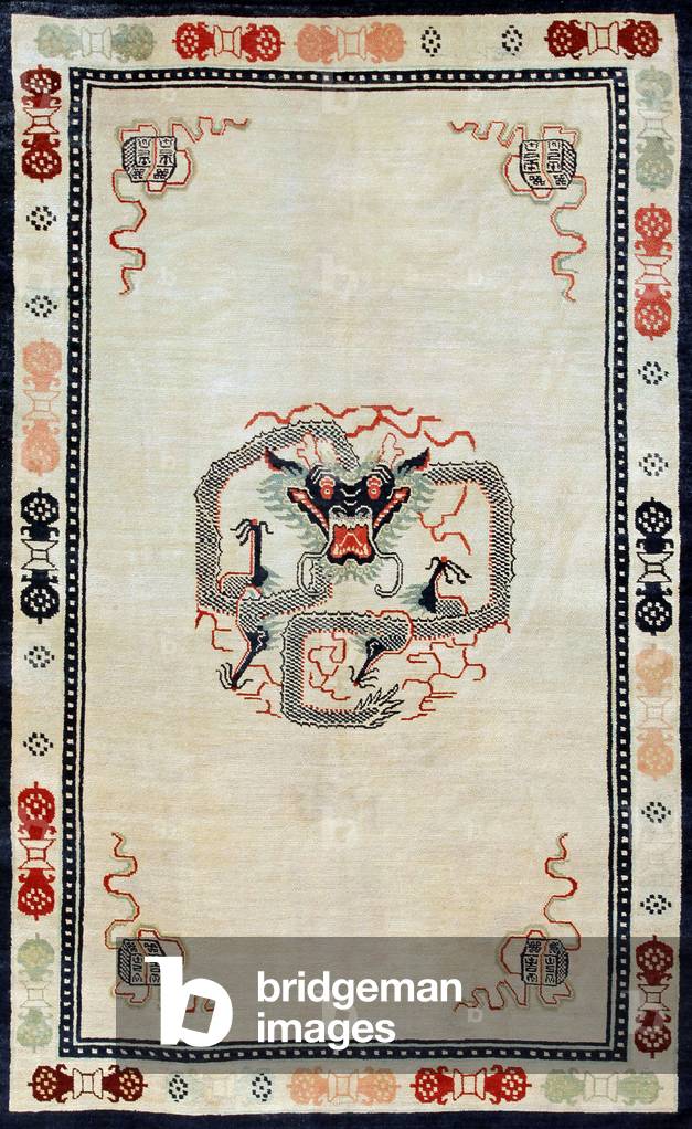 China / Tibet: A coiled Tibetan dragon represented on a 19th century Tibetan rug