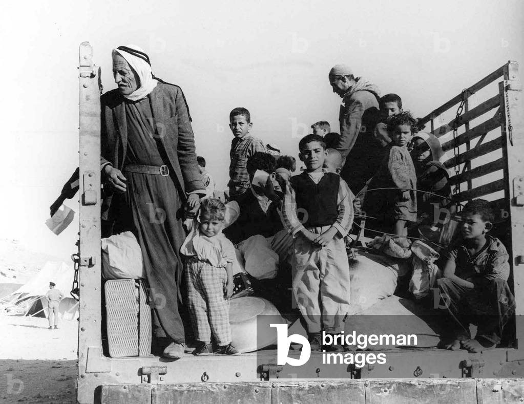Israel / Palestine: Palestinian refugees driven from their homes by Israeli forces ride into exile in the back of a truck, 1948