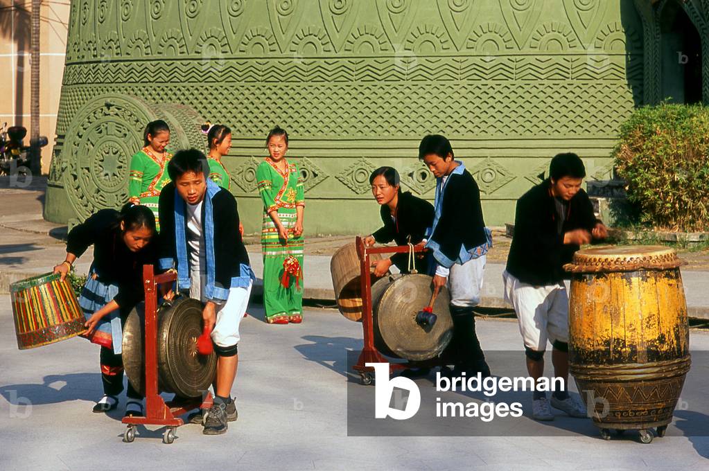 China: Playing Dong Son bronze drums at the Guangxi Provincial Museum, Nanning, Guangxi Province