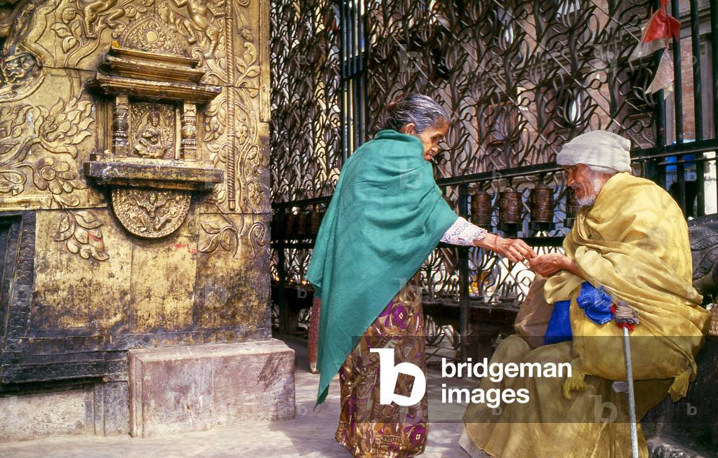 Nepal: Giving alms at the Seto Machindranath Temple, Kathmandu (1996)