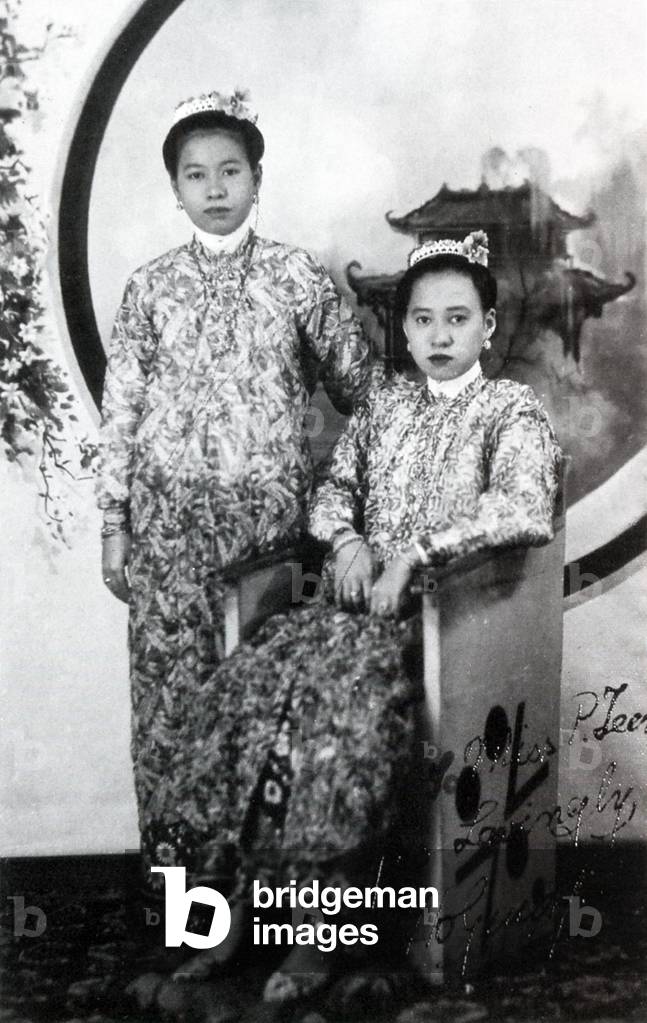 Malaysia / Singapore: Two young Nyonya women in traditional clothing, c. 1940s