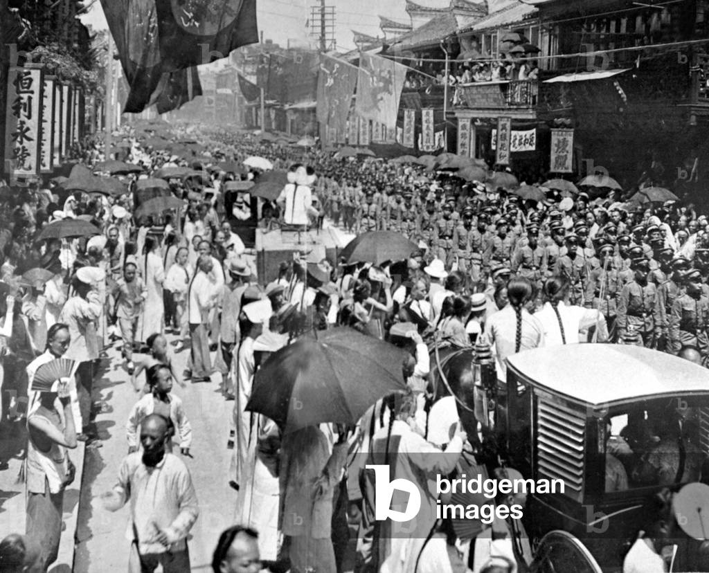 China: A military parade on on bustling Nanking (Nanjing) Road, 1906.