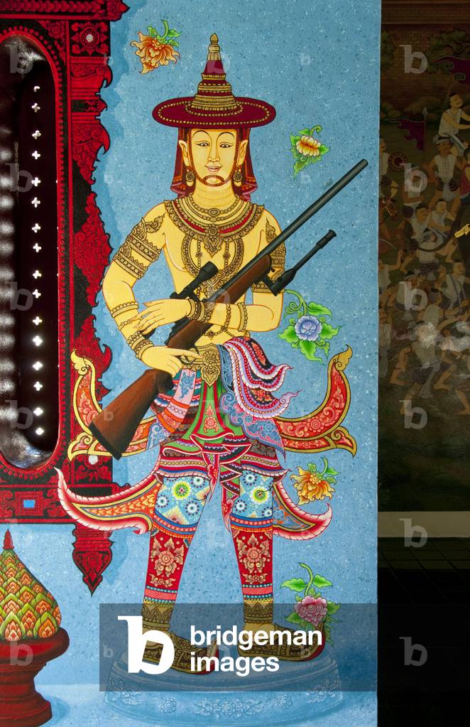 Thailand: Controversial mural of an Ayutthaya-era soldier holding a modern sniper rifle, Lak Muang (City Pillar shrine) Wat Chedi Luang, Chiang Mai. The modern weapons were painted over and replaced with traditional weapons in July, 2014