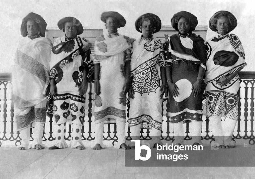 Tanzania / Zanzibar: Swahili women dress in high fashion wearing elaborate kanga, late 19th century