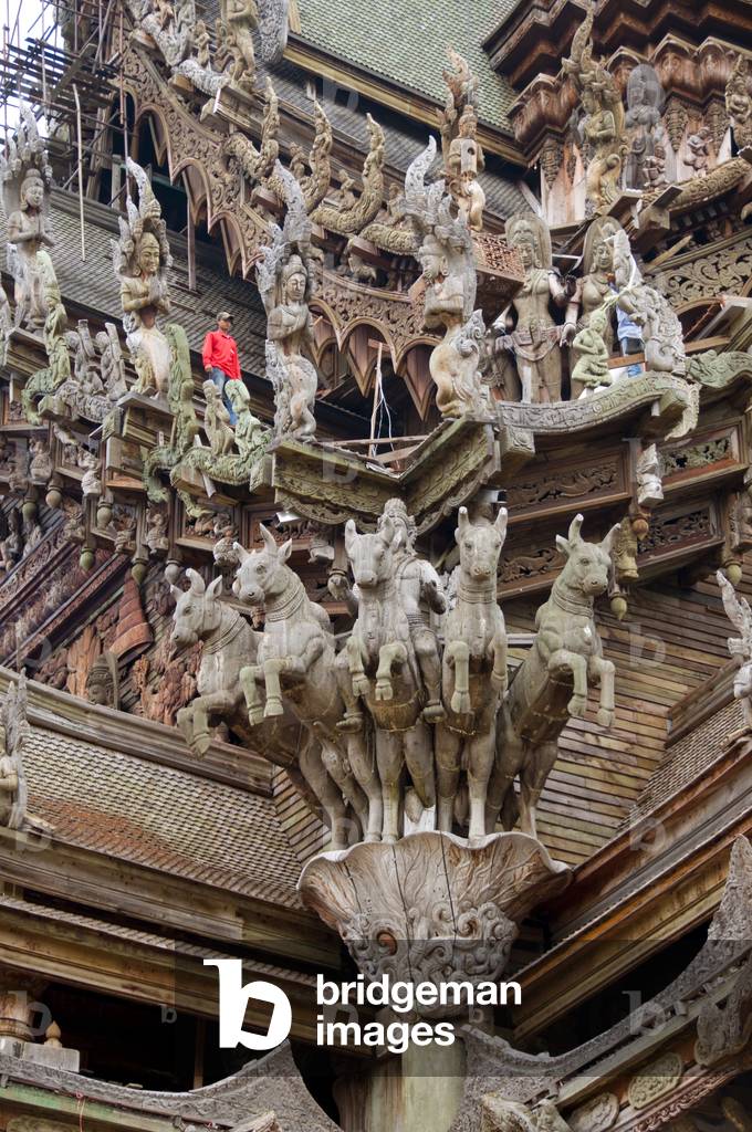 Thailand: Elaborate wooden carvings with worker on the roof, Sanctuary of Truth, Pattaya, Chonburi Province