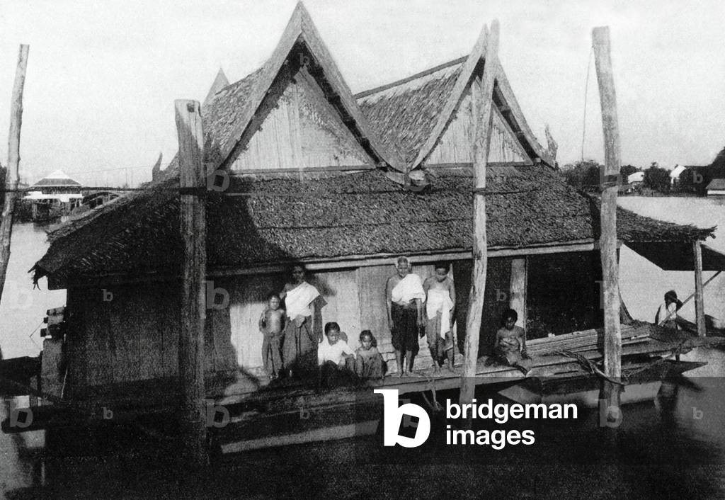 Thailand: A Siamese family poses for a photograph on their floating house on the Chao Phraya River near Bangkok, c. 1900.