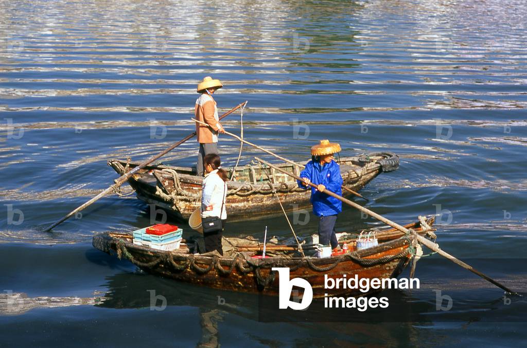 China: Hakka women ferrying customers across Waisha Harbour, Beihai, Guangxi Province