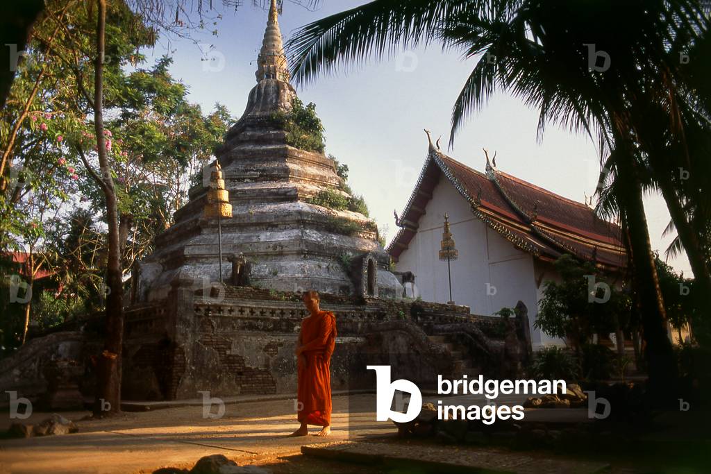 Thailand: A Buddhist monk quietly meditates in the late afternoon in a temple in Phrae, Northern Thailand