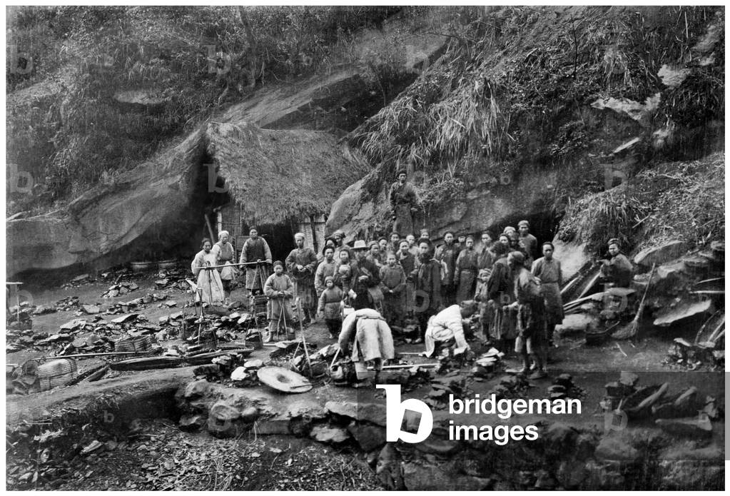 China: Coal miners outside a coal mine in the mountains west of Dazhu, Sichuan Province, 1909 (b/w photo)