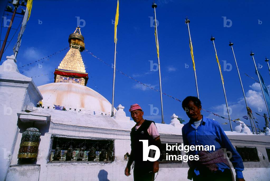 Nepal: Visitors below the all-seeing eyes of the great dome of Bodhnath (Boudhanath) stupa, Kathmandu
