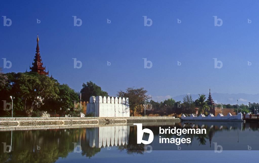 Burma / Myanmar: Early morning smoke and haze over Mandalay Fort with the Shan Plateau visible in the background (photo)