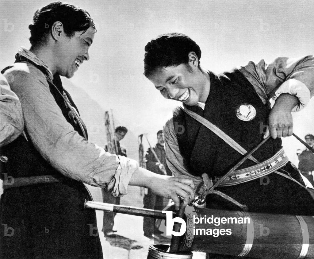 China / Tibet: Chinese propaganda image of happy Tibetans enjoying freshly-churned butter tea at the time of the Great Proletarian Cultural Revolution (1966-1976)