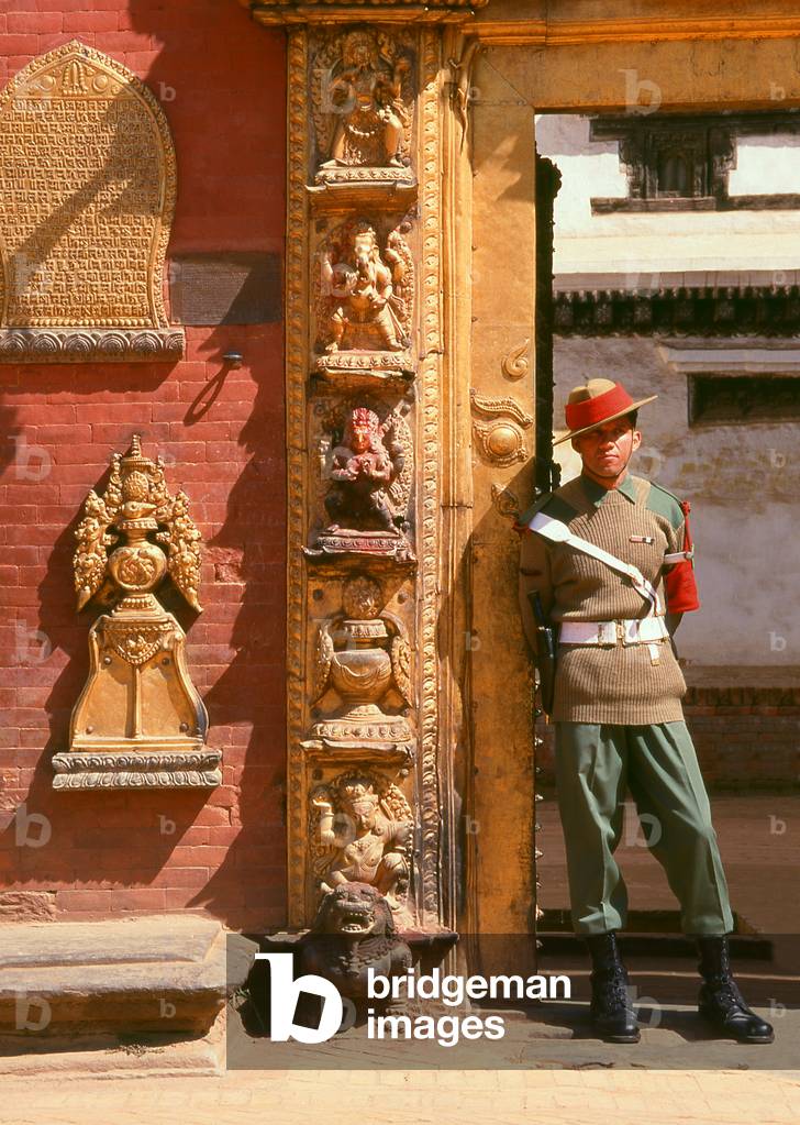 Nepal: A soldier guards the Golden Gate (Sun Dhoka) leading to the Taleju Temple within the Royal Palace complex, Bhaktapur, Kathmandu Valley (1997)