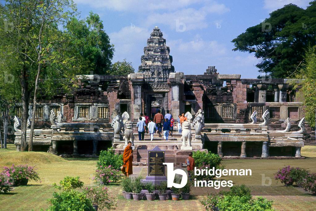 Thailand: Monk and other visitors at Prasat Hin Phimai, Phimai Historical Park, Nakhon Ratchasima Province. Phimai dates from the 11th and 12th century and was an important Khmer Buddhist temple and town in the Khmer empire
