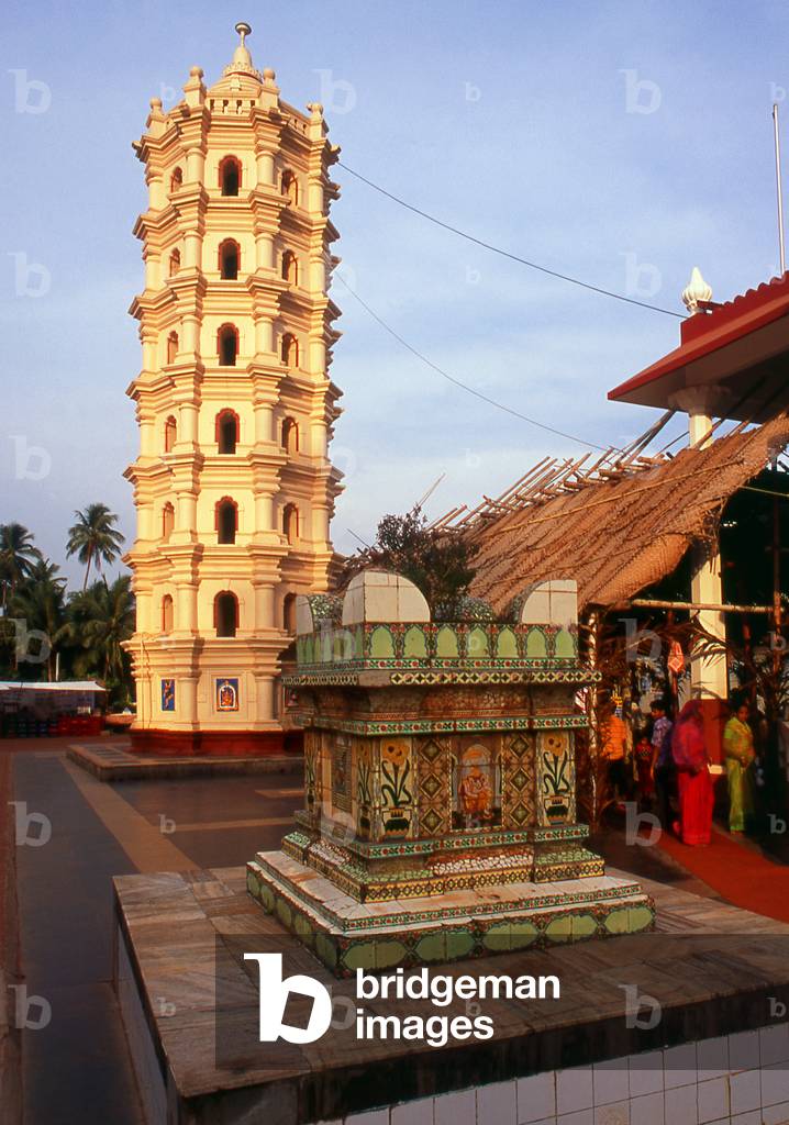 India: The 'tulasi chaura' or Holy Basil podium in front of the lamp tower (Deep Stambha) at the Shri Mangesh (Mangueshi) Temple, near Ponda, Goa