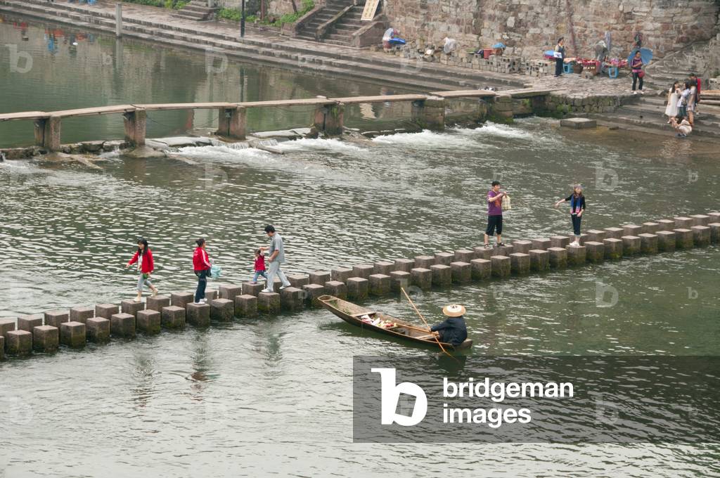 China: Stepping stones and wooden bridge across the Tuo River, Fenghuang, Hunan Province