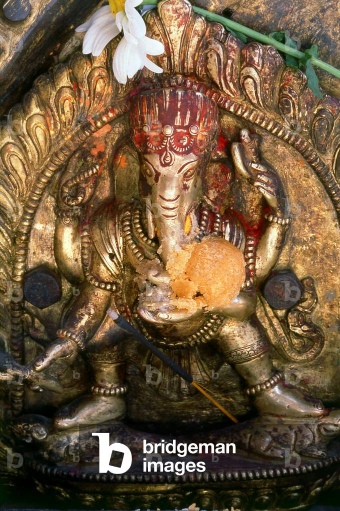 Nepal: Elaborate repoussé (repoussage) metalwork shows the Hindu god Ganesh at a shrine in the Kathmandu Valley
