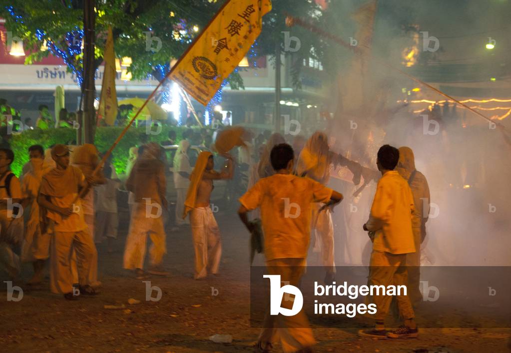 Thailand: The streets of Phuket Town exploding with firecrackers as the parade passes, Phuket Vegetarian Festival