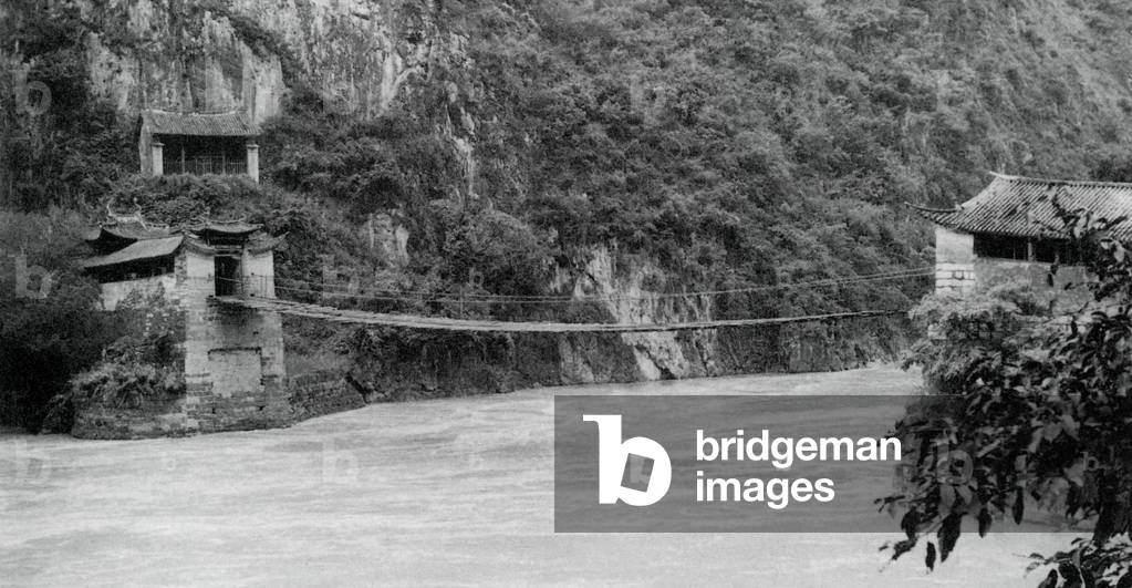 China: A suspension bridge over the Gang Guo gorge on the Mekong River, north of Baoshan in Yunnan Province, photographed in 1937.