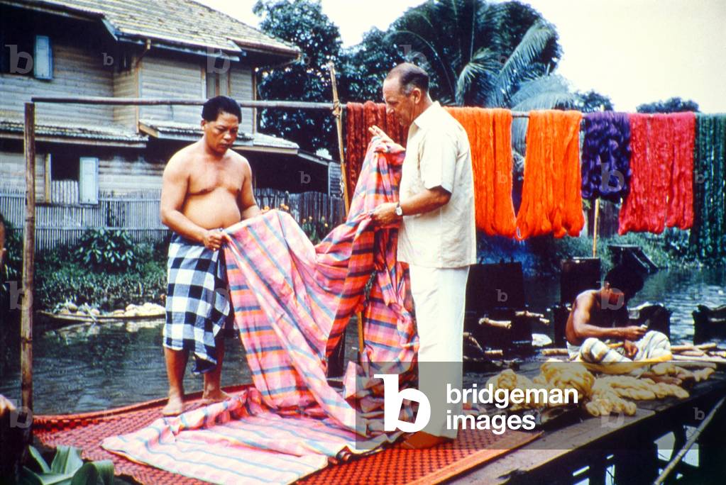 Thailand: Jim Thompson and a Cham weaver inspecting some silk, Ban Krua weaving community, Bangkok, c. 1962