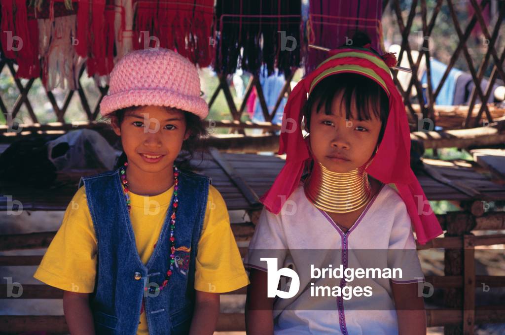 Thailand: Young Padaung (Long Neck Karen) girl and Thai girl, village near Mae Hong Son