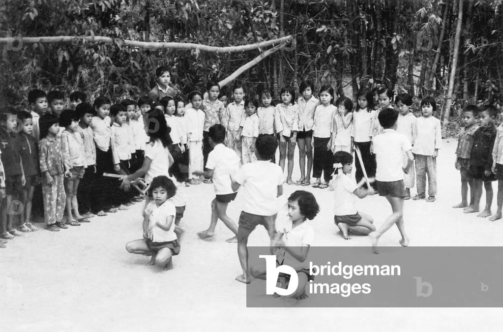 Vietnam: Children entertaining at Cu Chi, South Vietnam, Second Indochina War (Vietnam War) (1968)
