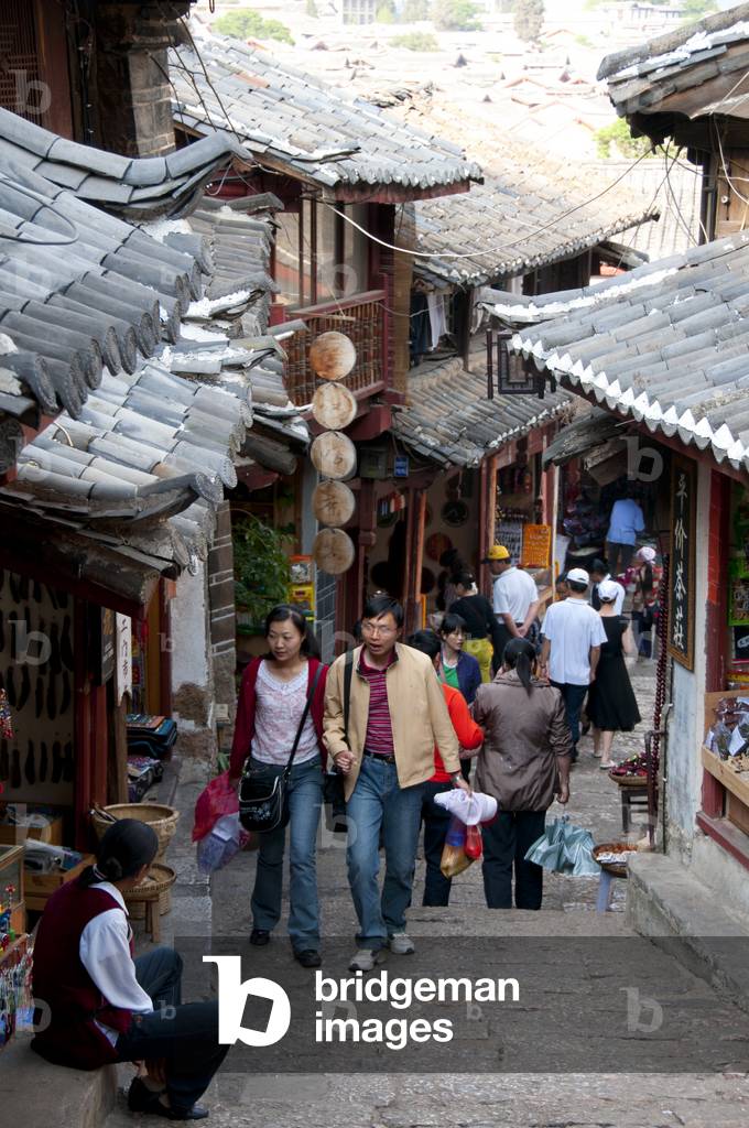 China: Tourists discovering the Old Town's back streets, Lijiang Old Town, Yunnan Province