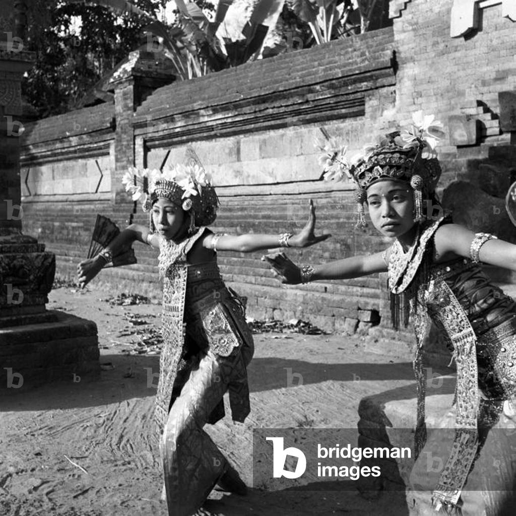 Indonesia: Two Legong dancers at a temple on the island of Bali, c. 1930