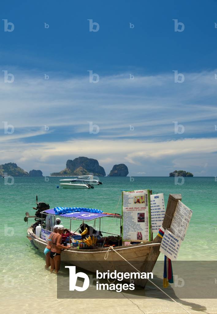 Thailand: Visitors buying snacks from one of the food boats lined up on the beach at Hat Tham Phra Nang, Krabi Coast