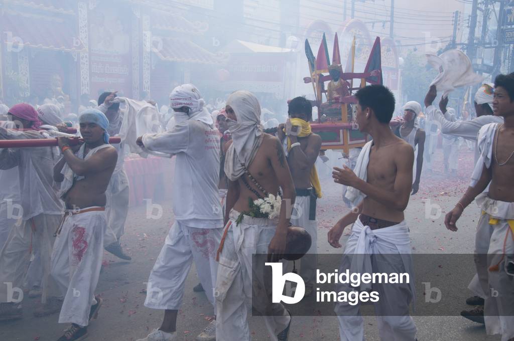 Thailand: Shrine bearers race through the streets to avoid exploding firecrackers and the deafening noise, Phuket Vegetarian Festival