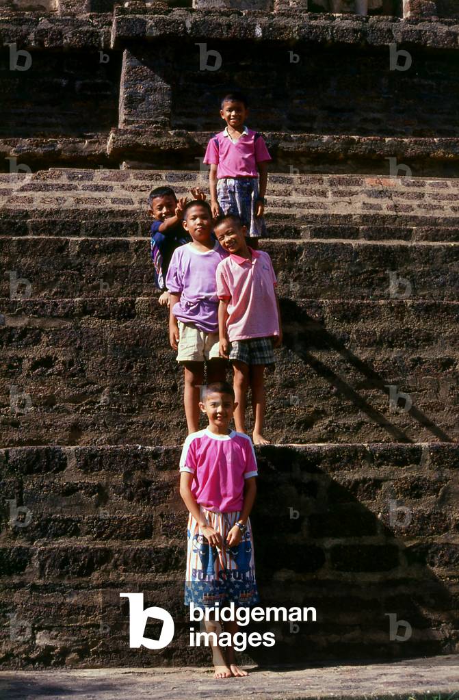 Thailand: Boys at the Chedi Suwanna Chang Kot (or Mahapon Chedi), Wat Chama Thewi, Lamphun, northern Thailand