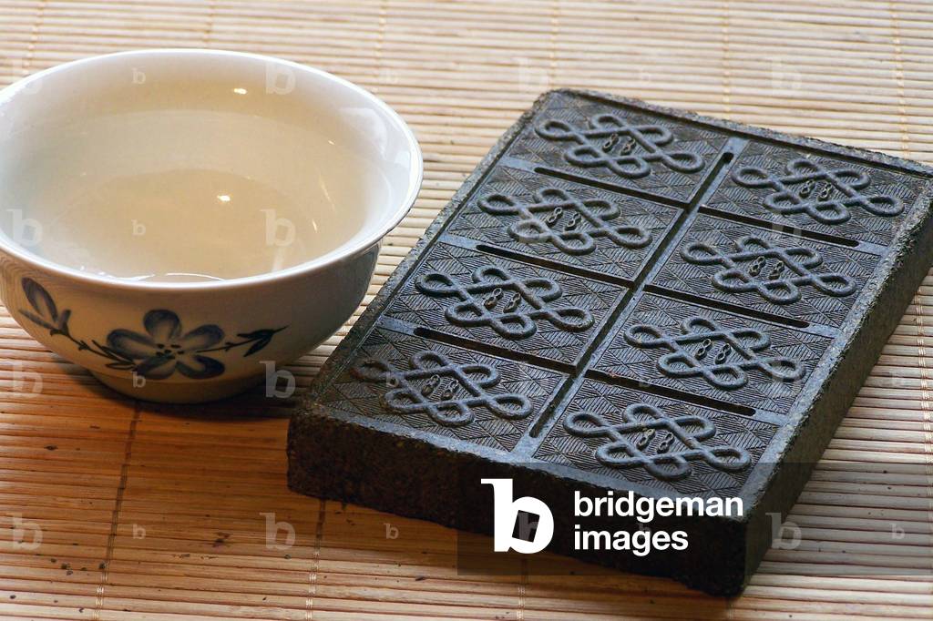 China: Compressed brick tea or 'zhuancha' from southern Yunnan, scored for breaking into smaller pieces