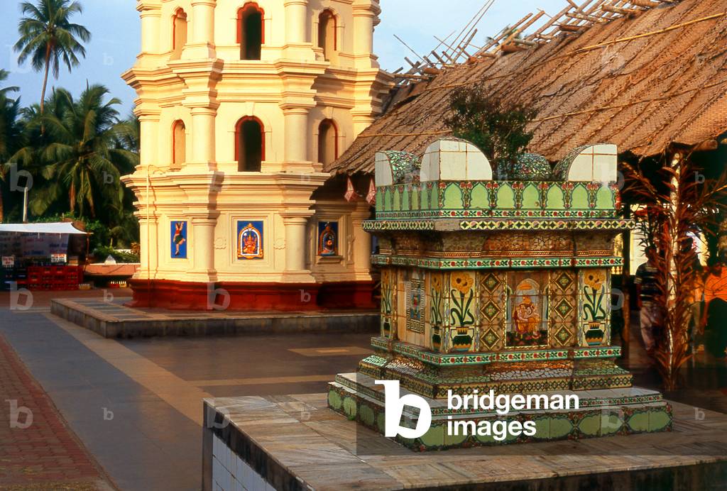 India: The 'tulasi chaura' or Holy Basil podium in front of the lamp tower (Deep Stambha) at the Shri Mangesh (Mangueshi) Temple, near Ponda, Goa