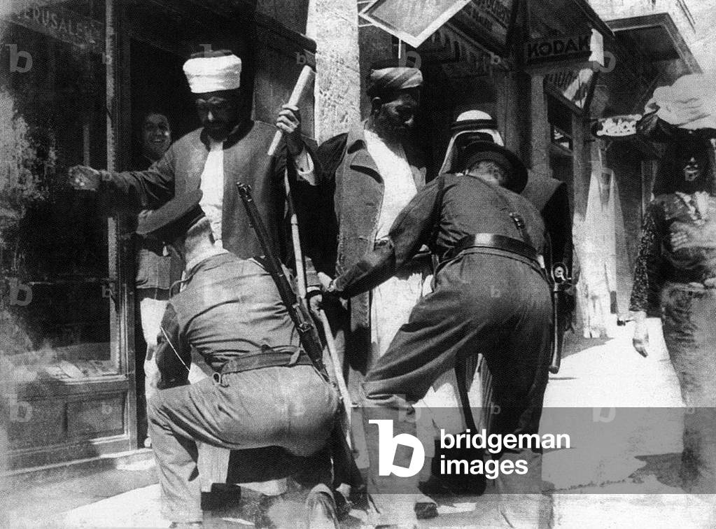 Israel / Palestine: Palestinian Muslim elders searched in a Jerusalem street by Israeli forces, 1948 (photo)