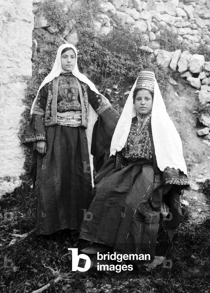 Palestine: Two Palestinian women of Bethlehem in traditional clothing, c. 1920