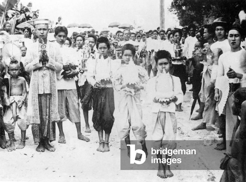 Thailand: A 1900 photograph of a young Siamese man in fine attire on his way to assume his monastic duties at a Buddhist monastery in Nakhon Phanom in Isarn, northeastern Siam.