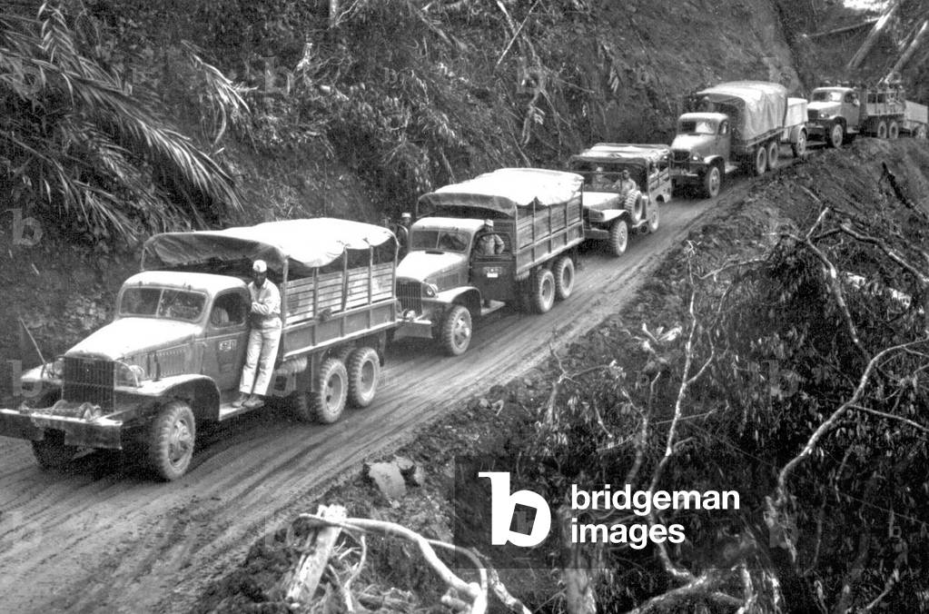 Burma / Myanmar: US supplied Army trucks wind along the side of a mountain over the Ledo supply road from India into Burma, 1944