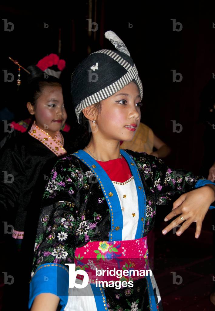 Laos: A girl, wearing traditional Hmong costume, dancing at a Baci (Baasii) ceremony, Luang Prabang