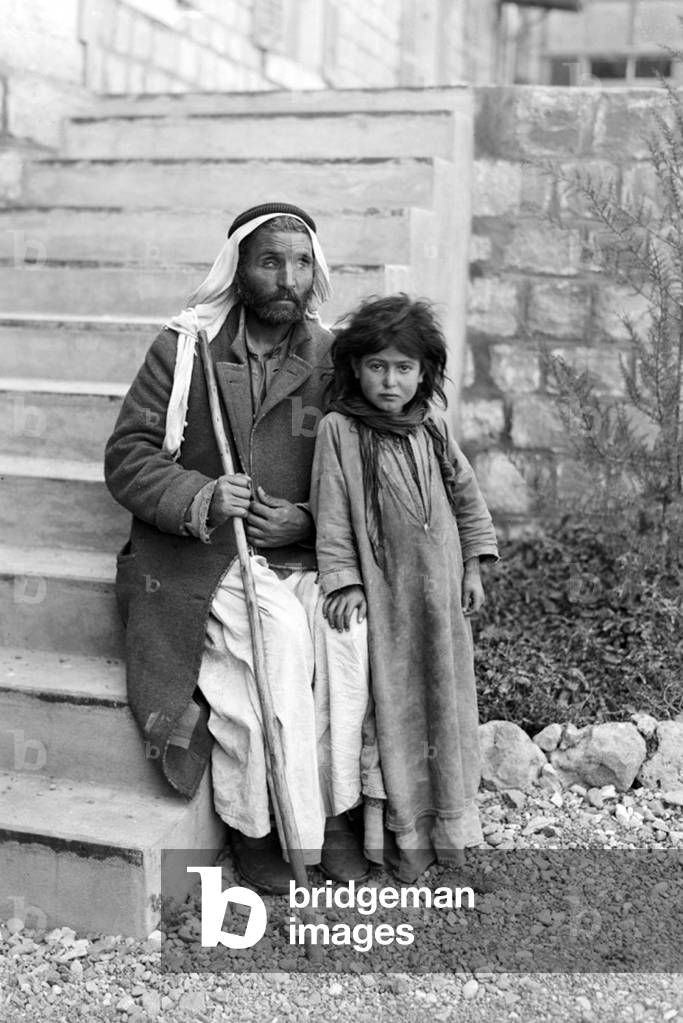 Palestine: A blind Palestinian man with a young girl, possibly his daughter, c. 1910