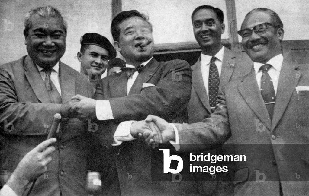 Laos: Prince Boun Oum (left), Prince Souvanna Phouma (centre), and Prince Souphanouvong (right), shake hands after reaching an agreement to form a coalition government, thus averting what had threatened to become a major war, 11 June, 1962