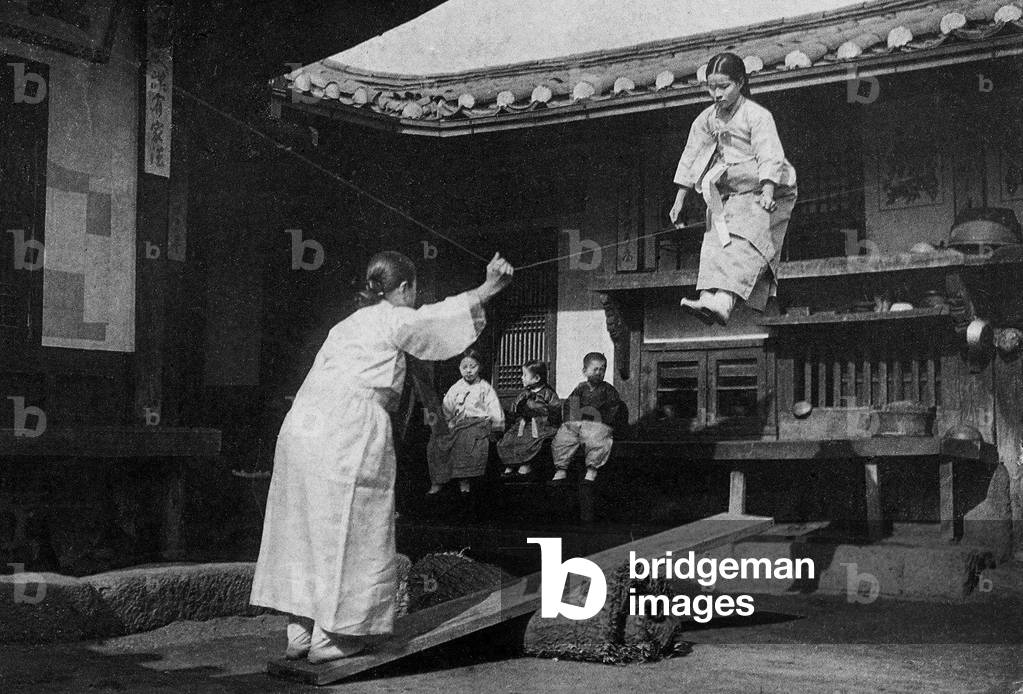 Korea: Two young Korean women playing on a see-saw, Seoul, early 20th century