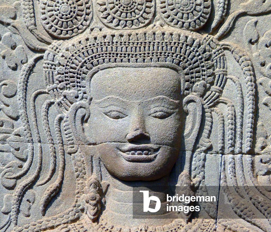 Cambodia: A smiling apsara at Angkor Wat - this apsara is the only one out of almost two thousand at Angkor Wat who is showing her teeth (11th century)