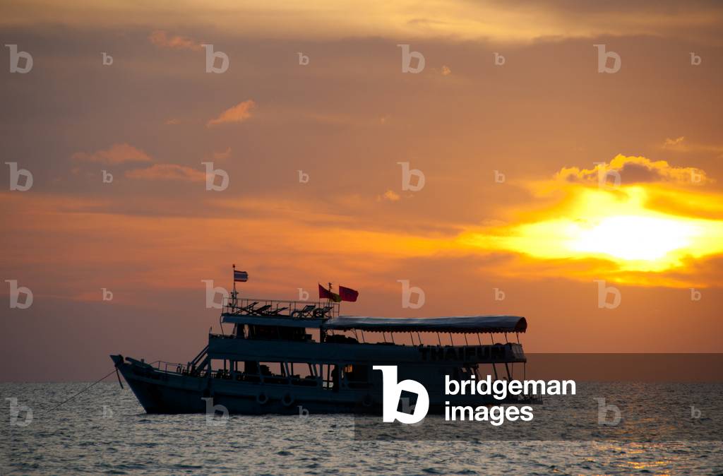 Thailand: A dive boat anchored at sunset near Sai Khao Beach ( Hat Sai Khao), Ko Chang, Trat Province