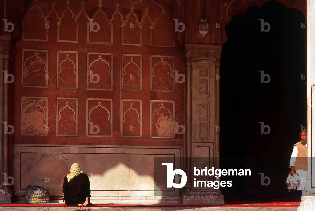 India: A woman prays outisde the main prayer hall at the Jama Masjid, India's largest mosque, Delhi