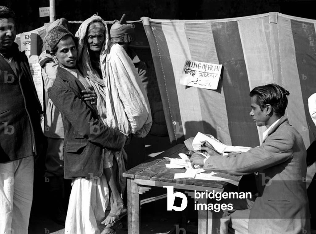 India: First Lok Sabha general election, Delhi, January 1952. An elderly woman is carried to vote at a polling station near the Jama Masjid (Friday Mosque) in Old Delhi