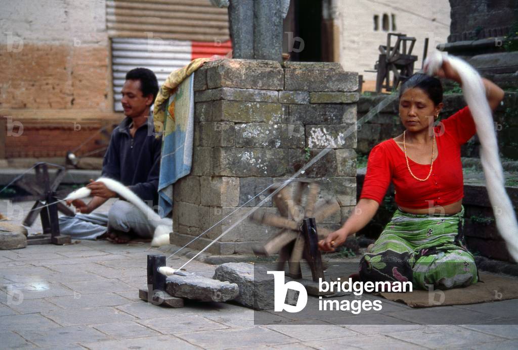 Nepal: Spinning wool on a street in Kathmandu (1996)